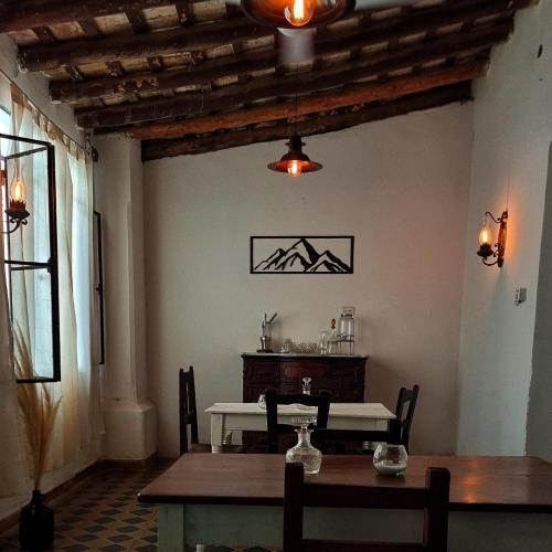 a dining room with a table and a table and chairs at Las catalinas hospedajes in Chilecito