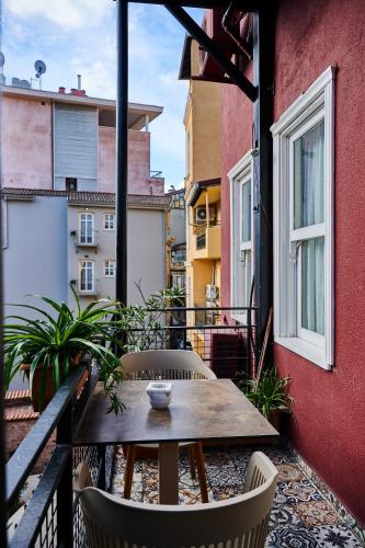 a balcony with a table and chairs on a building at Faik Pasha Hotels Special Category Beyoglu Istanbul in Istanbul