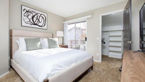 a bedroom with a large white bed and a window at Landing Modern Apartment with Amazing Amenities (ID8118X32) in Temecula