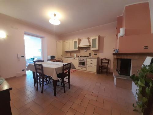 a kitchen with a table and chairs and a fireplace at Casal dei Colli in Amelia