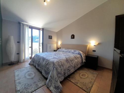 a bedroom with a bed and a large window at Casal dei Colli in Amelia