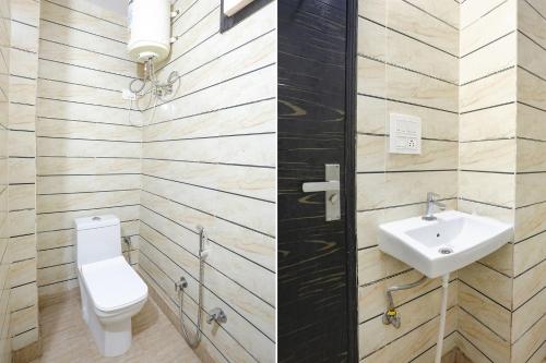a bathroom with a toilet and a sink at FabExpress ASP Royal Residency Inn- Janakpuri in New Delhi