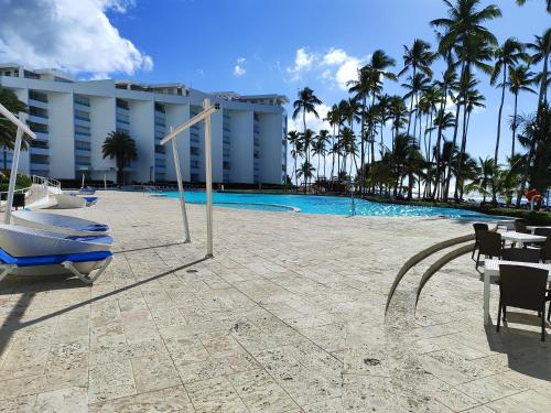 a resort swimming pool with palm trees and a hotel at Vista marina Marbella in Juan Pedro