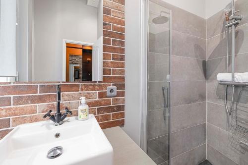 a bathroom with a sink and a shower at Gentilhomme in Paris