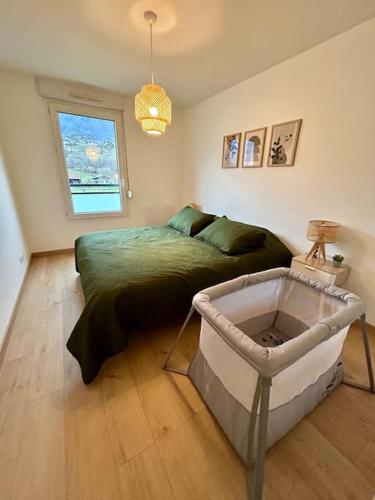 a bedroom with a bed and a large window at Superbe appartement T3 en résidence avec piscine in Albertville