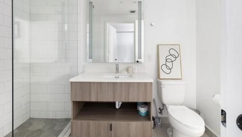 a bathroom with a sink and a toilet and a mirror at Landing Modern Apartment with Amazing Amenities (ID1283X920) in Fort Lauderdale