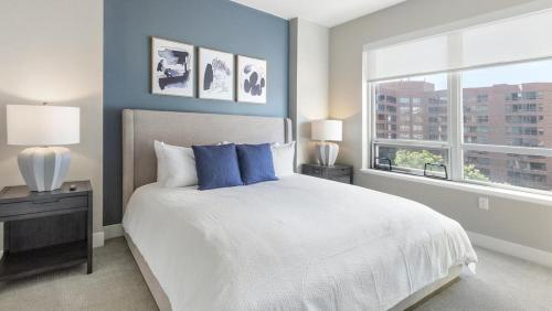 a bedroom with a bed with blue walls and a window at Landing Modern Apartment with Amazing Amenities (ID6240X71) in Denver