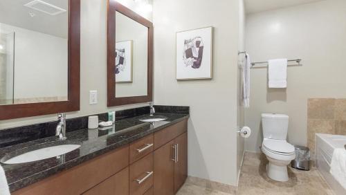 a bathroom with a sink and a toilet and a mirror at Landing Modern Apartment with Amazing Amenities (ID6240X71) in Denver