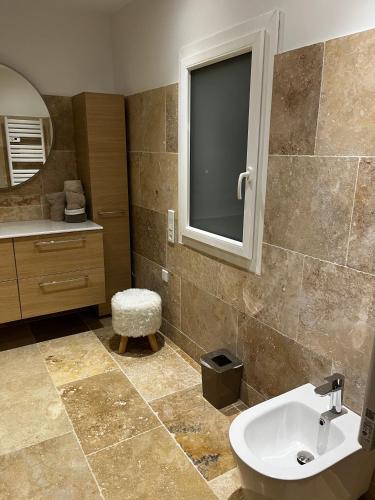 a bathroom with a sink and a mirror at Maison N°133 in Saint-Rémy-de-Provence