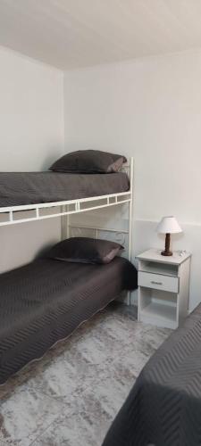 a bedroom with two beds and a nightstand with a lamp at SAN BERNARDO in San Bernardo