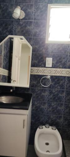 a bathroom with a white toilet and a sink at SAN BERNARDO in San Bernardo