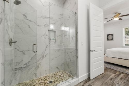 a bathroom with a shower with a glass door at The Sand Emperor With Heated Pool And Game Room in Destin