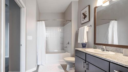 a bathroom with a sink and a toilet and a tub at Landing Modern Apartment with Amazing Amenities (ID7989X60) in Greenville