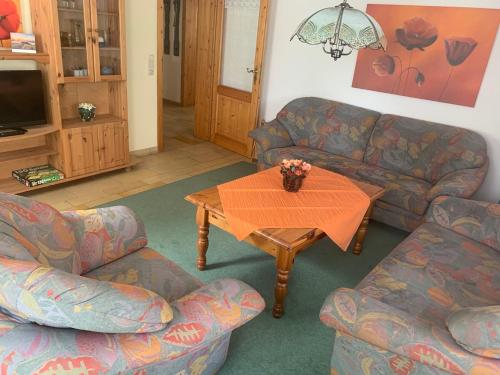 a living room with two couches and a table at Ferienhof Klein in Gunzenhausen