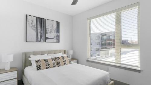 a white bedroom with a bed and a window at Landing Modern Apartment with Amazing Amenities (ID1791X13) in Richmond