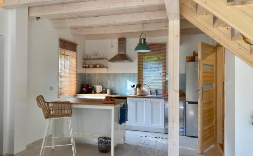 a kitchen with a counter and a chair in it at Stodoła Drwęck in Drwęck
