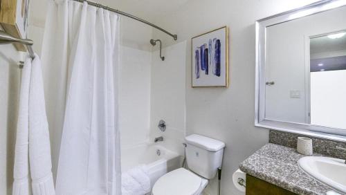 a white bathroom with a toilet and a sink at Landing Modern Apartment with Amazing Amenities (ID8735X33) in Los Angeles