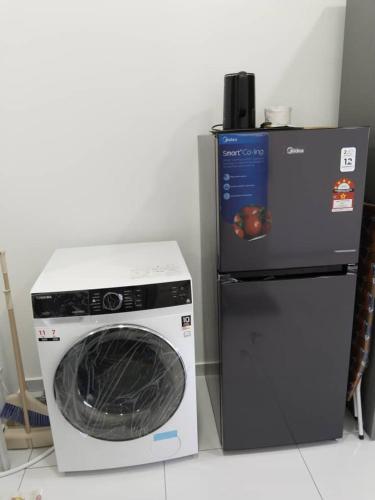 a washing machine and a refrigerator in a room at Cosy Sky Tree 5 min walk to Aeon Bukit Indah JB Legoland Exclusive Room Suite By HomeSpace in Johor Bahru