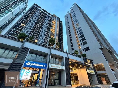 two tall buildings in a city with a store at Cosy Sky Tree 5 min walk to Aeon Bukit Indah JB Legoland Exclusive Room Suite By HomeSpace in Johor Bahru