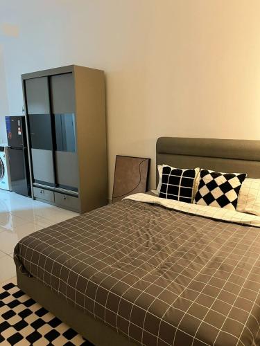 a bedroom with a bed with a checkered floor at Cosy Sky Tree 5 min walk to Aeon Bukit Indah JB Legoland Exclusive Room Suite By HomeSpace in Johor Bahru