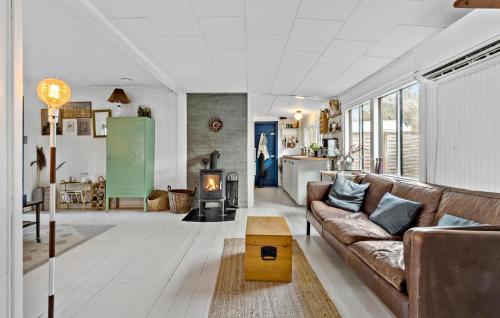 a living room with a couch and a fireplace at Nice Home In Vig With Sauna in Vig