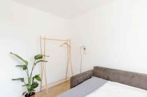 a bedroom with a bed and a lamp and a plant at Central London Stylish Room in London