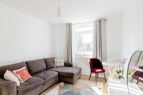 a living room with a couch and a chair at Central London Stylish Room in London