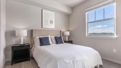 a white bedroom with a bed and a window at Landing Modern Apartment with Amazing Amenities (ID8094X36) in Fort Myers Villas