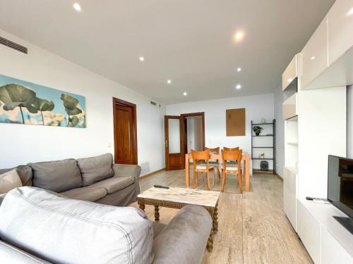 a living room with a couch and a table at Apartment Picasso in Vilanova i la Geltrú