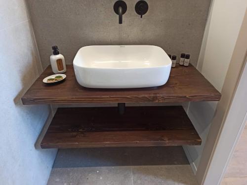 a white sink on a wooden table in a bathroom at Art Studios Gialova Navarino in Gialova