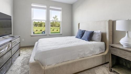 a bedroom with a large bed and two windows at Landing Modern Apartment with Amazing Amenities (ID9455X92) in Middleburg