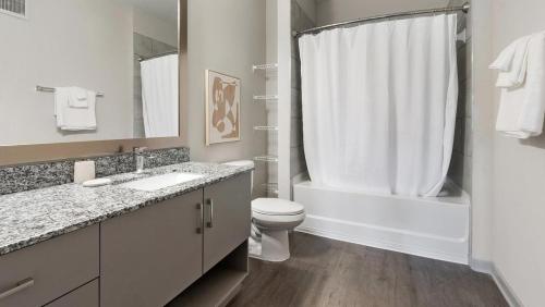 a bathroom with a toilet and a sink and a shower at Landing Modern Apartment with Amazing Amenities (ID9455X92) in Middleburg