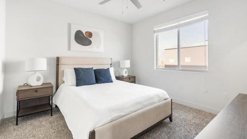 a white bedroom with a bed and a window at Landing Modern Apartment with Amazing Amenities (ID7745X98) in Albuquerque