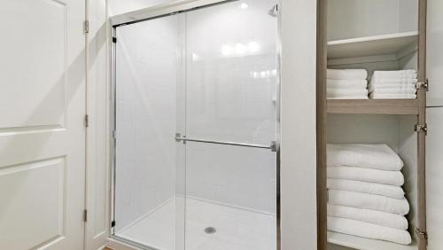 a glass shower door in a bathroom with towels at Landing Modern Apartment with Amazing Amenities (ID7745X98) in Albuquerque