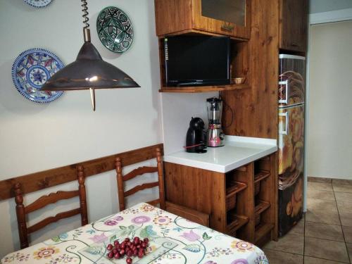 a small kitchen with a table and a microwave at 3 bedrooms apartement at Bronchales in Bronchales