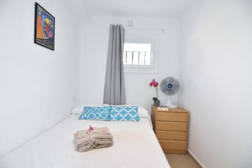 a white bedroom with a bed and a fan at RNET - Casa del Sol Roses Costa Brava in Roses