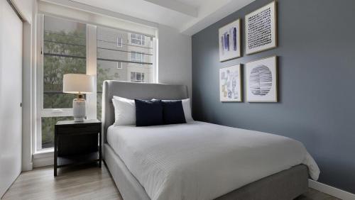 a blue bedroom with a bed and a window at Landing Modern Apartment with Amazing Amenities (ID9822X42) in Portland