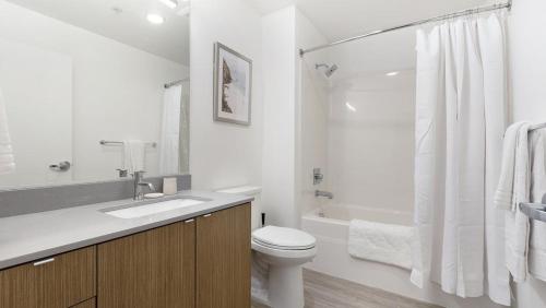 a white bathroom with a toilet and a shower at Landing Modern Apartment with Amazing Amenities (ID9822X42) in Portland