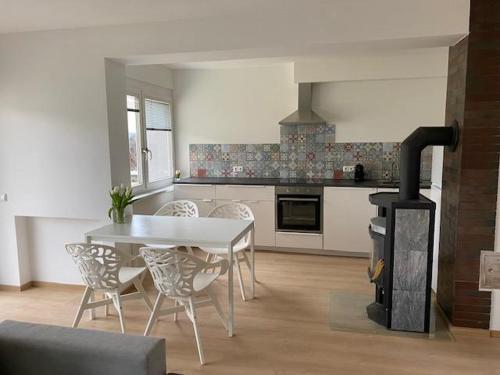 a kitchen with a table and a stove in it at Ferienwohnung Seeluft in Keutschach am See