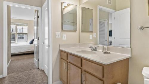 a bathroom with a sink and a mirror at Landing Modern Apartment with Amazing Amenities (ID8354X41) in Leesburg
