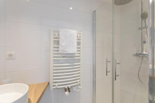 a white bathroom with a shower and a sink at Ty Far - Villa pour 8 vue sur le Port in Erquy