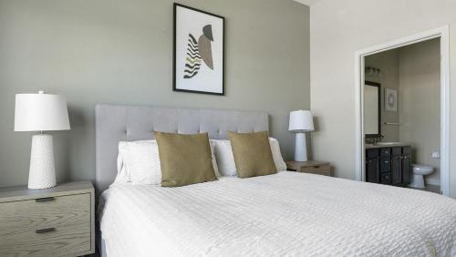 a bedroom with a large white bed with pillows at Landing Modern Apartment with Amazing Amenities (ID3512X6) in El Paso