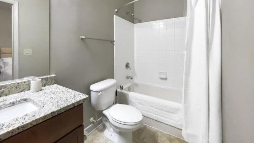 a white bathroom with a toilet and a shower at Landing Modern Apartment with Amazing Amenities (ID1228X214) in Greenville