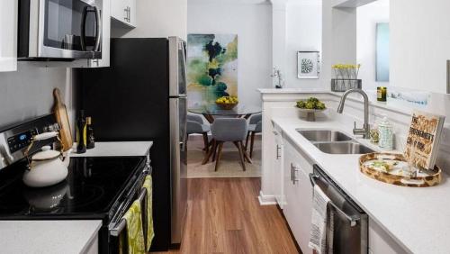 a kitchen with a sink and a stove top oven at Landing Modern Apartment with Amazing Amenities (ID1201X608) in Baton Rouge