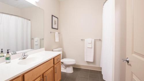 a white bathroom with a sink and a toilet at Landing Modern Apartment with Amazing Amenities (ID4566X63) in Detroit
