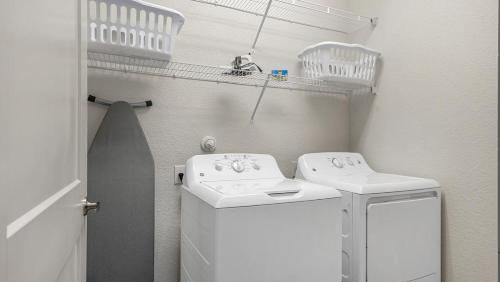 a small white laundry room with a washer and dryer at Landing Modern Apartment with Amazing Amenities (ID8459X09) in San Antonio
