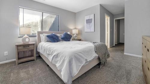 a bedroom with a large bed with blue pillows at Landing Modern Apartment with Amazing Amenities (ID7684X1) in Lexington