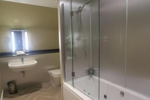 a bathroom with a shower and a toilet and a sink at The Inn At Lathones in St. Andrews
