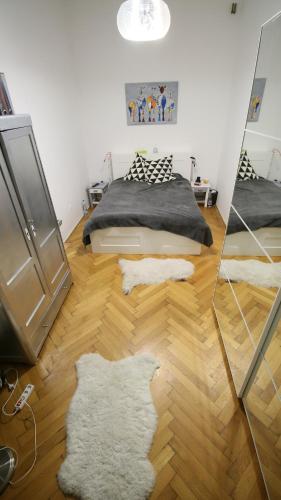 a bedroom with a bed and a mirror at Cosy loft flat next to the Margaret island in Budapest