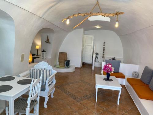 a living room with a couch and a table at Palm Tree Hill in Oia